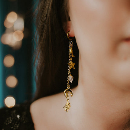Cosmic-inspired gold dangle earrings star moon motif