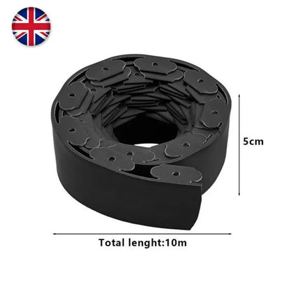 Flexible plastic garden edging shaped around flower bed curve