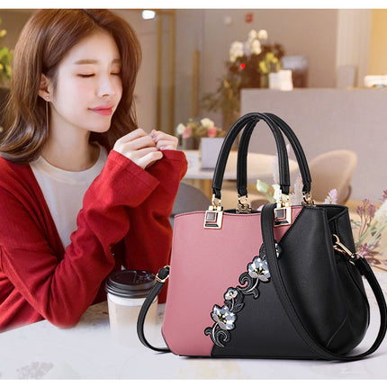 Pink and black color match floral handbag for ladies.
