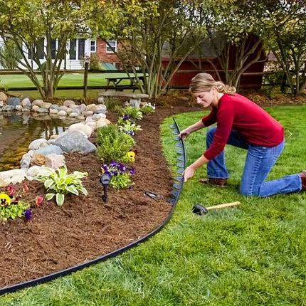 Lady using plastic garden border edging kit